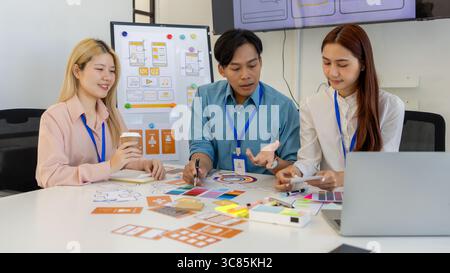 ux, ui, mobile app web designers are brainstorming to design a visual display that customers will see and feel comfortable using so color tones and la Stock Photo