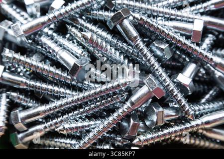 Galvanized large wood screws in a heap close-up. Stock Photo