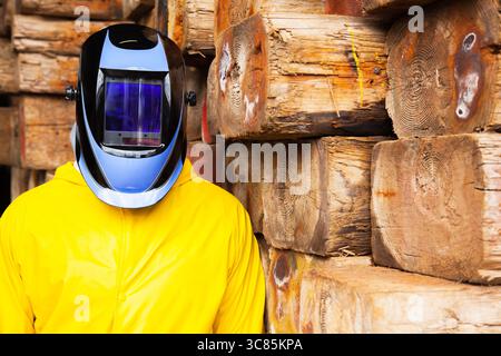 A man in a protective chemical suit and a welding mask on his head. Stock Photo