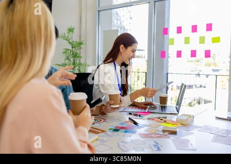 ux, ui, mobile app web designers are brainstorming to design a visual display that customers will see and feel comfortable using so color tones and la Stock Photo