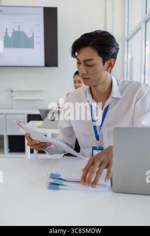 the atmosphere of the company's employees working together, the finance department staff work with the accounting department, a group of businessmen a Stock Photo