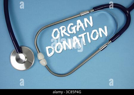 Organ Donation text with stethoscope on blue background Stock Photo
