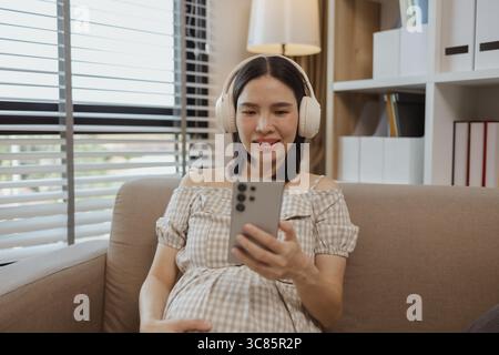 a pregnant mother is relaxing on a sofa in her own home, a woman's pregnancy, family, a woman was very happy because she was pregnant and would soon g Stock Photo