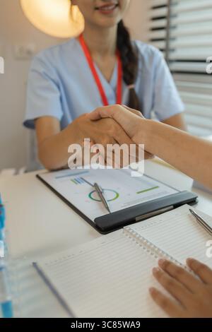 two doctors are shaking hand, consultation between two doctors in the office, two medical students are discussing treatment guidelines for a patient, Stock Photo