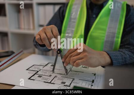 businessman or architect with model of a house working in office, architect working in office with blueprints, engineer inspect architectural plan, sk Stock Photo