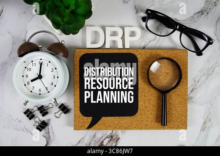 DRP - Distribution Resource Planning acronym with alarm clock and magnifying glass, business concept background Stock Photo