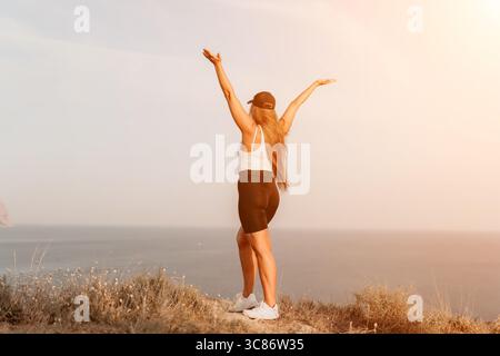 Woman Celebrating on a Clifftop Stock Photo
