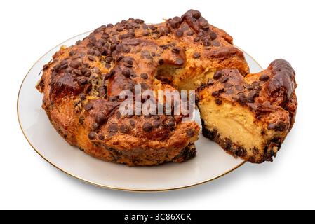 Homemade chocolate chip cake with a slice cut on a white plate with a golden border, isolated on white with clipping path included Stock Photo