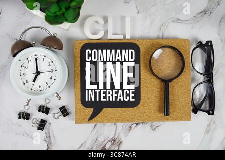CLI Command Line Interface text with alarm clock and magnifying glass on marble background Stock Photo