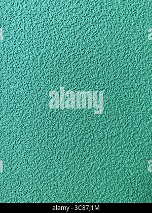 Textured turquoise wall surface suitable for background and design element in creative projects. Mobile photo Stock Photo