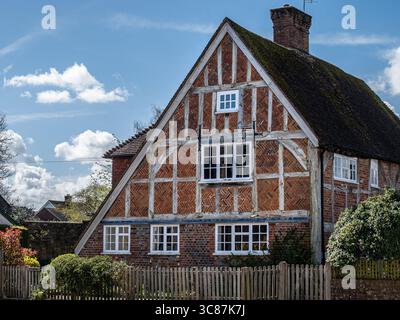 An old tudor house displaying herringbone brickwork and wooden beams in the village of East Meon, Hampshire, England. Stock Photo