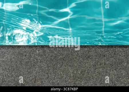 Ripple Water in swimming pool with sun reflection Stock Photo