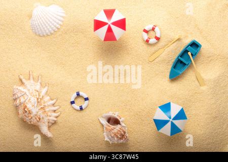 Creative summer background made with sea shells and summer things on sand background. Minimal summer aesthetic concept. Stock Photo