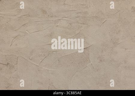 The scratched up surface of an old European stucco wall creates a textured background plate. Stock Photo