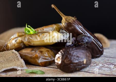 ready-to-freeze eggplants in a vacuum bag lie on a paper baking sheet. Stock Photo