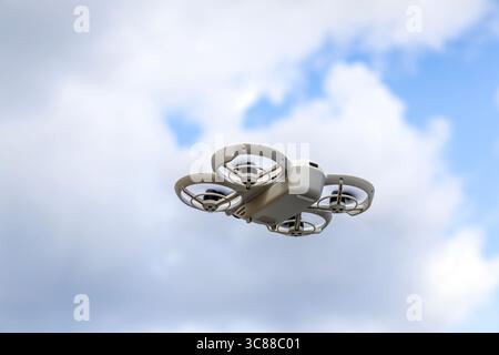 A portable photography drone flying in the sky Stock Photo