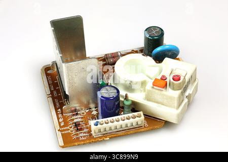 A close-up of a circuit board with various electronic components. Isolated on a white background. Stock Photo