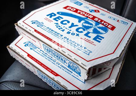 Domino's Pizza carryout order pizza boxes from Carside Delivery on the front passenger seat of a vehicle. (USA) Stock Photo