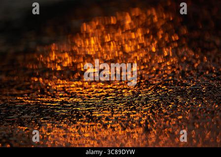 Gilded Ripples Dance Upon Molten Waters Stock Photo