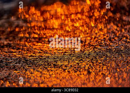 Gilded Ripples Dance Upon Molten Waters Stock Photo