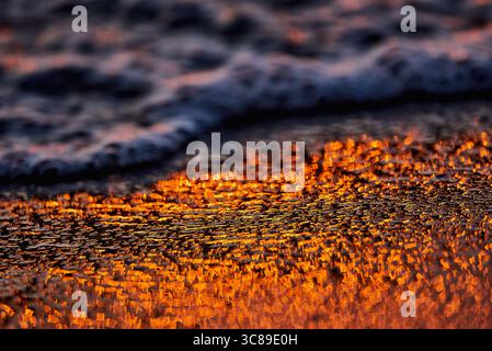 Gilded Ripples Dance Upon Molten Waters Stock Photo