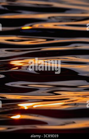 Gilded Ripples Dance Upon Molten Waters Stock Photo
