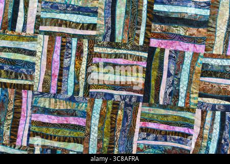 A patchwork quilt with many different colored squares. Abstract background Stock Photo