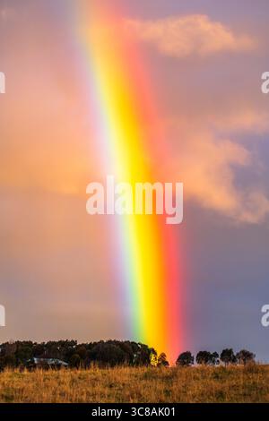 Rainbow over the countryside at Blayney in the Central West of NSW, Australia. Stock Photo