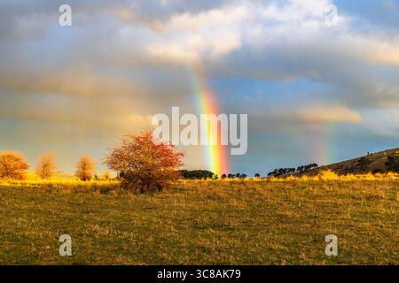 Rainbow over the countryside at Blayney in the Central West of NSW, Australia. Stock Photo