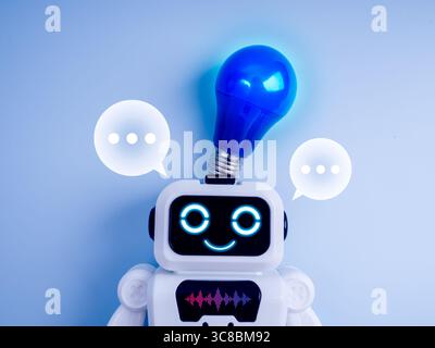 Smart AI chatbot assistant, customer service automate support tools technology concept. Happy white cute robot smile with ideas light bulb on head and Stock Photo