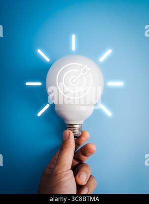 Creative ideas, business goal and success, innovation technology concept. Target icon on big white LED sphere light bulb with glowing radius graphics, Stock Photo