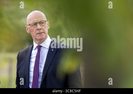 File photo dated 16/07/25 of First Minister John Swinney during a visit to Clyde Gateway's Magenta Business Park, Glasgow, to turn on Scotland's first renewable district heating system and to announce funding for regeneration projects. The First Minister has been urged to take urgent action to stop the increasing levels of plastic pollution facing Scotland. In an open letter signed by 18 environmental and civil groups, the SNP leader has been urged to do more to protect Scots from the effects of plastic. Issue date: Monday August 4, 2025. Stock Photo