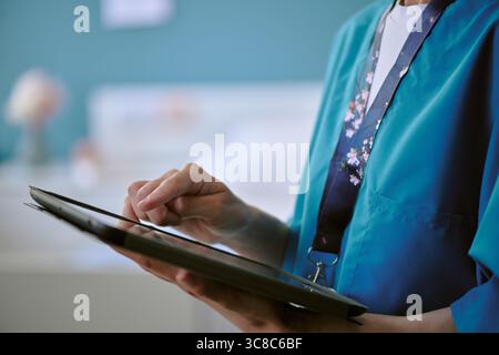 Middle Aged Caucasian Woman Nurse Using Digital Tablet in Hospital Room Stock Photo
