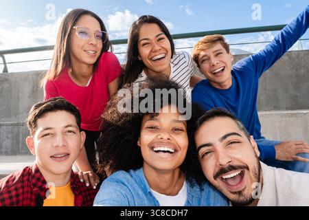 Multiracial friends taking selfie celebrating outdoors in summer Stock Photo