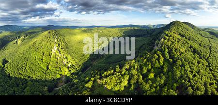 Mountain landscape with rocks, cross on top of mountain, sunlit hills. Picturesque landscape of Male (Little) Karpaty, Slovakia, Slovakia mountain ran Stock Photo