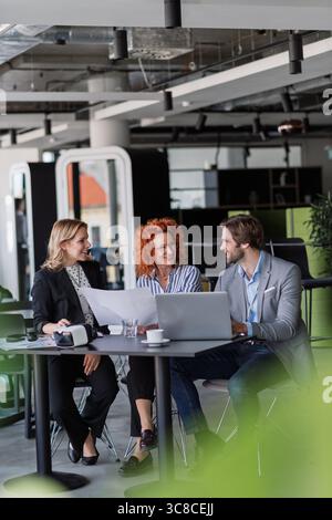 Creative team having discussion over coffee about project strategy. Stock Photo