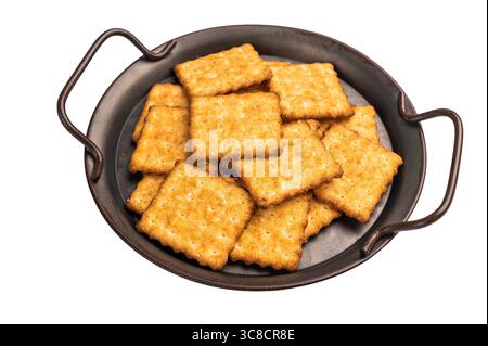 Square salty crackers in wooden tray isolated on white background, top view. Stock Photo