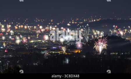 View of a dazzling display of fireworks erupting across the cityscape, illuminating the night sky with vibrant colors and festive cheer, Graz, Styria, Austria. Stock Photo