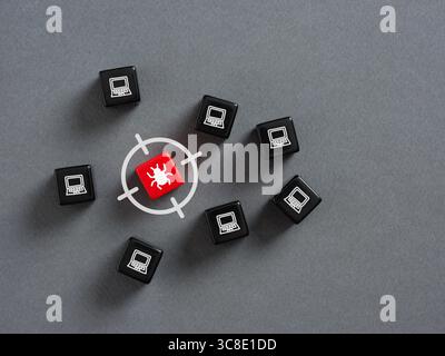 Red dice with virus symbol targeted among black dice with laptop symbols, representing cybersecurity threat and vulnerability of computer networks Stock Photo