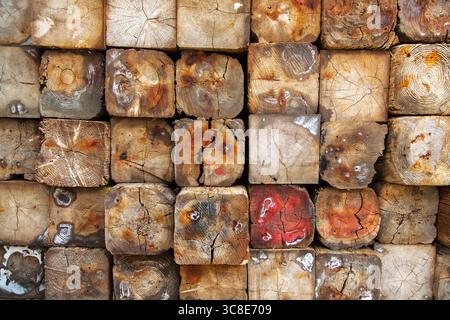 Large building blocks of wood, folded into a bundle, tightly to each other. Background from wooden blocks. Stock Photo