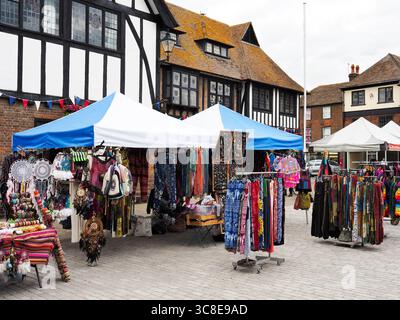 Colourful clothing stall at a Sunday market on the Cattle Market in Sandwich Kent England Stock Photo