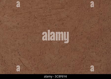 Terracotta texture close-up. Rough with scratches surface of unglazed fired clay, background, close-up, high resolution. Stock Photo