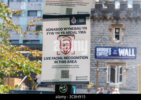 Notice with information about live facial recognition in this area, sign in Welsh and English in Bute Park near Cardiff Castle, South Wales, UK Stock Photo