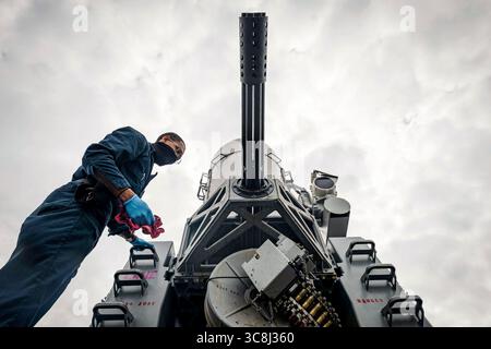 February 6, 2021 - South China Sea - Fire Controlman 2nd Class Dondre Summers, from Waldorf, Md., performs maintenance on a close-in weapons system (CIWS) aboard the Arleigh Burke-class guided-missile destroyer USS John S. McCain (DDG 56). McCain is assigned to Destroyer Squadron (DESRON) 15, the Navy largest forward-deployed DESRON and the U.S. 7th Fleet principal surface force. (Credit Image: © Markus Castaneda/U.S. Navy/ZUMA Wire/ZUMAPRESS.com) Stock Photo