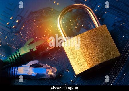 Network ethernet cables near padlock on computer motherboard. Internet data privacy information security concept Stock Photo