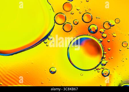 Yellow water bubbles abstract background. Oil drops in water abstract psychedelic pattern image Stock Photo