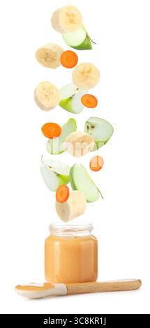 Baby food. Slices of apple, banana and carrot falling into jar of puree on white background Stock Photo