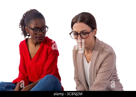 Two businesswomen working together on a project, networking and problem solving Stock Photo