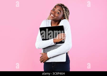 Technology Lover. Excite black woman hugging personal computer Stock Photo