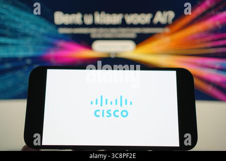 Roosendaal, The Netherlands - August 04, 2025: A mobile phone displaying the company logo of Cisco, with the company website in the background. Stock Photo